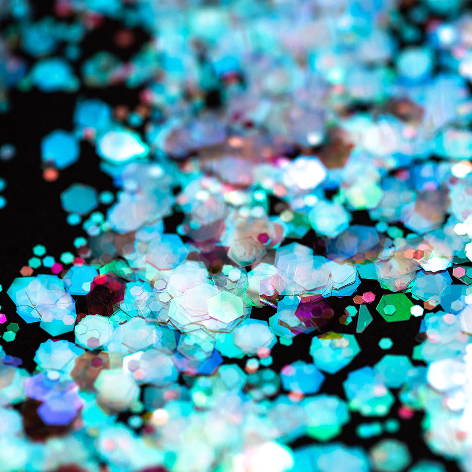 An image of Ariel Chunky Glitter by DreamSQNS scattered on a black surface