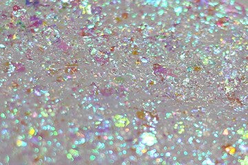 A swatch of Pixie Glitter Paste from DreamSQNS, spread on a white surface