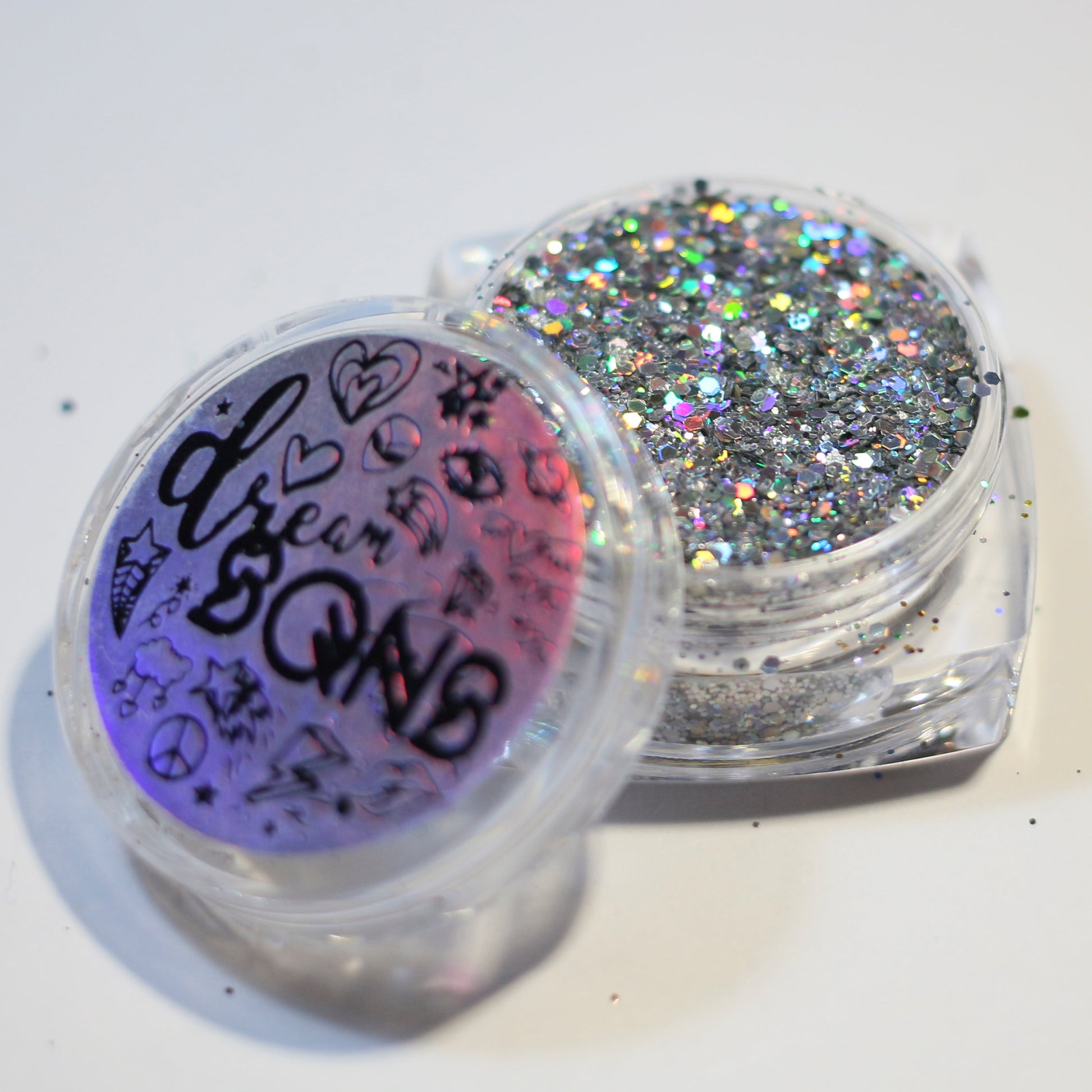 A photograph of DreamSQNS Holographic Glitter in shade Unicorn with the full branded component