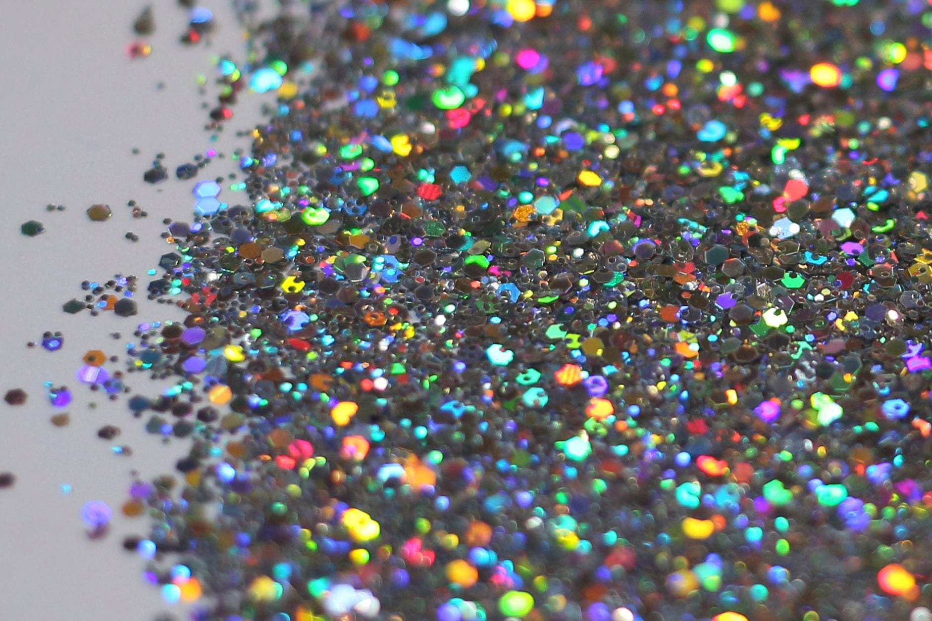 An image of Unicorn Holographic Glitter from DreamSQNS scattered on a white surface
