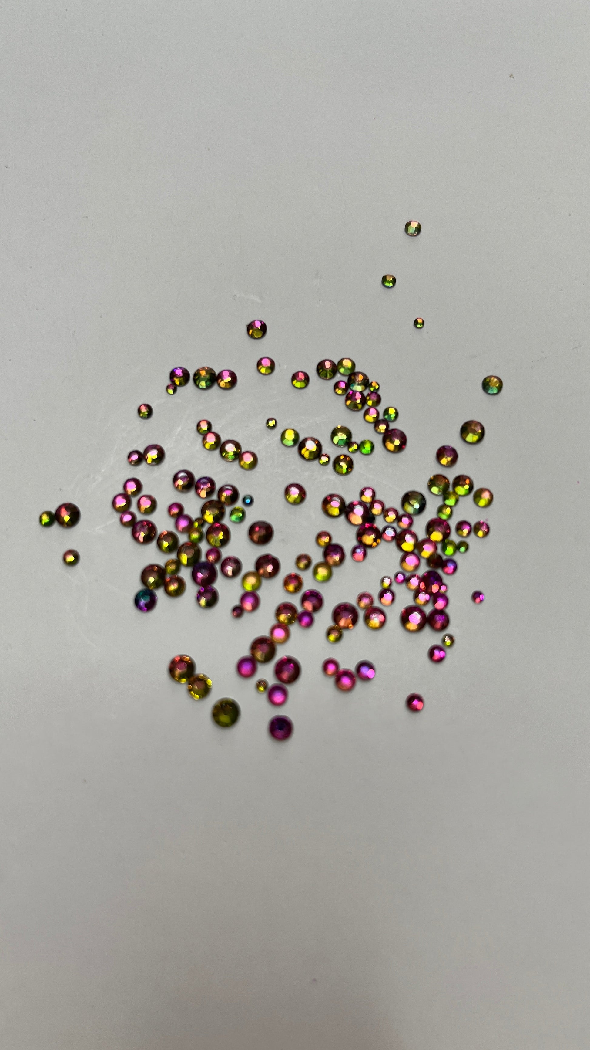 A image of the Watermelon Crystals by DreamSQNS Glitter scattered on a white platform